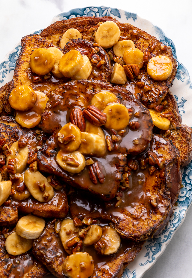 This Easy Bananas Foster French Toast is one of our favorite breakfast recipes! Crispy slices of buttery brioche are topped with a delicious homemade bananas foster sauce made from dark rum, butter, brown sugar, heavy cream, and crunchy pecans. Delicious on it's on, but devilishly good with whipped cream or vanilla ice cream!