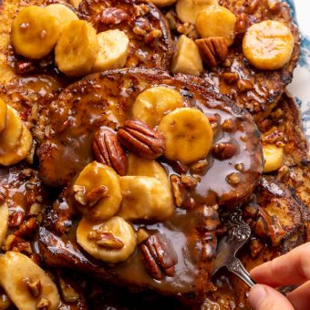 This Easy Bananas Foster French Toast is one of our favorite breakfast recipes! Crispy slices of buttery brioche are topped with a delicious homemade bananas foster sauce made from dark rum, butter, brown sugar, heavy cream, and crunchy pecans. Delicious on it's on, but devilishly good with whipped cream or vanilla ice cream!