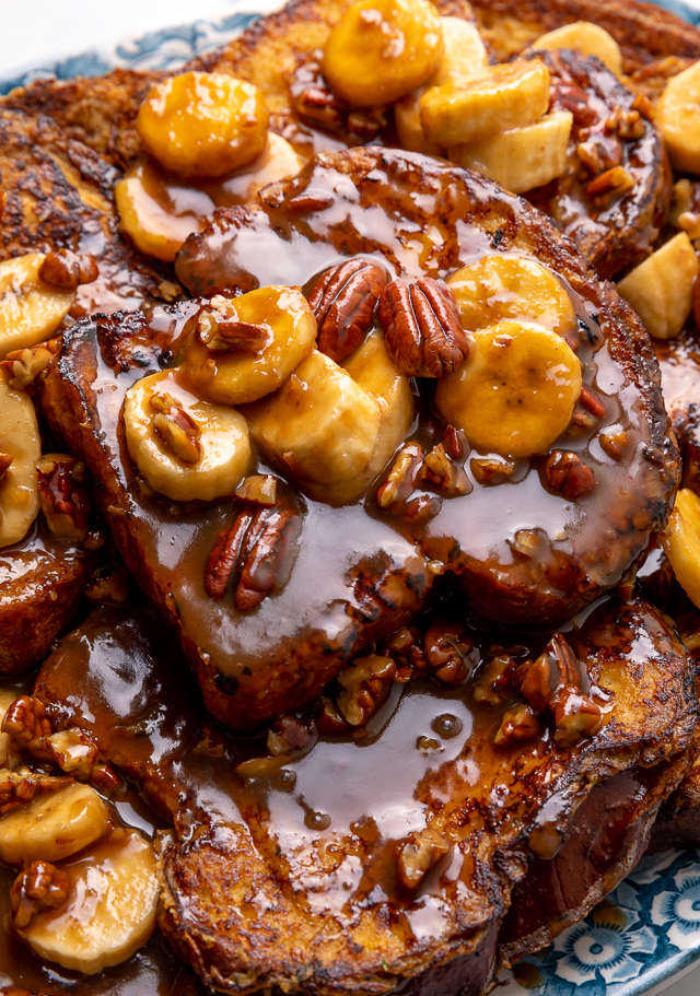 This Easy Bananas Foster French Toast is one of our favorite breakfast recipes! Crispy slices of buttery brioche are topped with a delicious homemade bananas foster sauce made from dark rum, butter, brown sugar, heavy cream, and crunchy pecans. Delicious on it's on, but devilishly good with whipped cream or vanilla ice cream!